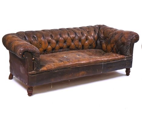 AN EARLY 20TH CENTURY BROWN LEATHER UPHOLSERED CHESTERFIELD SOFAOn turned supports, 195cm wide; 62cm high