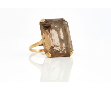 A 9CT GOLD AND SMOKY QUARTZ SINGLE STONE RINGClaw set with a large cut cornered rectangular smoky quartz, London probably 196