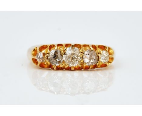 A VICTORIAN 18CT GOLD AND DIAMOND SET FIVE STONE RINGMounted with a row of cushion shaped diamonds graduating in size to the 