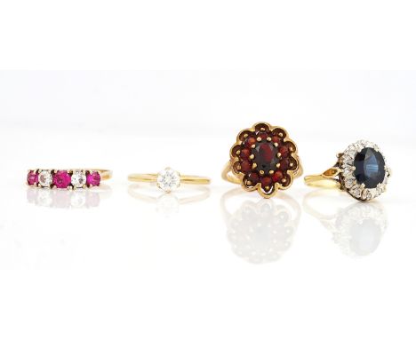 AN 18CT GOLD, SAPPHIRE AND DIAMOND OVAL CLUSTER RING AND THREE FURTHER GOLD AND GEM SET RINGSThe 18ct gold ring claw set with
