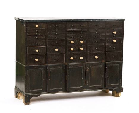 AN EARLY 20TH CENTURY DENTIST'S CABINETThe marble top over thirty five various drawers and five cupboards, 140cm wide; 108cm 