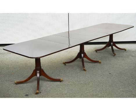 A GEORGE III MAHOGANY TRIPLE PILLAR DINING TABLEOn twelve downswept supports to include two extra leaves, 102cm wide; 273cm l