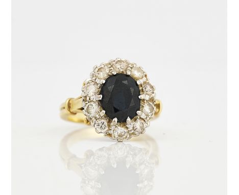 A GOLD, SAPPHIRE AND DIAMOND OVAL CLUSTER RINGClaw set with the oval cut sapphire in a surround of ten circular cut diamonds,