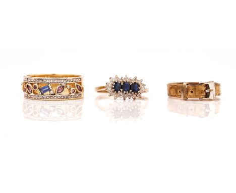 THREE 9CT GOLD RINGS (3)Comprising; a sapphire and diamond ring claw set with three oval cut sapphires in a surround of circu