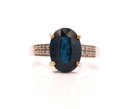 A 9CT WHITE GOLD RINGClaw set with an oval cut kyanite between colourless gem set shoulders, ring size W, gross weight 6.7 gm
