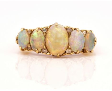A GOLD, OPAL AND DIAMOND RINGMounted with a row of oval opals graduating in size to the centre stone and with pairs of diamon