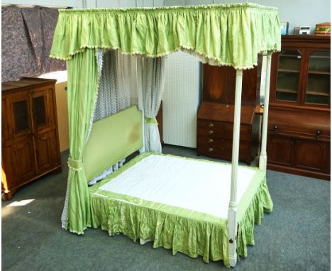 A 20TH CENTURY GREEN AND CREAM PAINTED FOURPOSTER BEDWith pleated canopy and reeded supports, 173cm wide; 210cm long; 270cm h