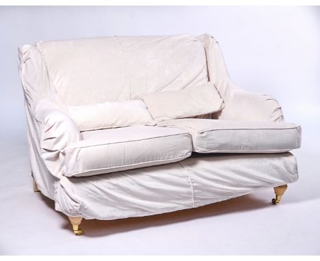 A MODERN TWO SEATER SOFAWith loose upholstery, on fluted baluster supports, 136cm wide; 85cm highCondition report:&nbsp;Solid