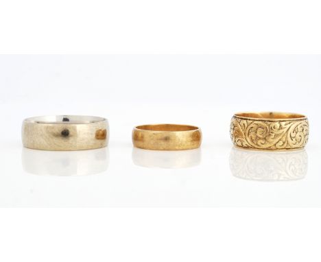 THREE 9CT GOLD WEDDING RINGS (3)Comprising; a scroll decorated wide band wedding ring, London 1968, ring size R and a half, a