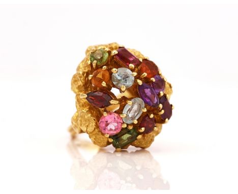 AN 18CT GOLD AND VARICOLOURED GEMSTONE SET CLUSTER RINGThe coloured gemstones including amethyst, peridot, tourmaline and gar
