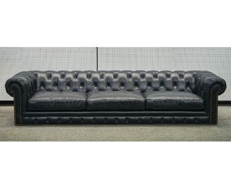 A LARGE STUDDED BLACK LEATHER UPHOLSTERED CHESTERFIELD SOFAWith button back, 300cm wide; 65cm highCondition report:&nbsp;Good