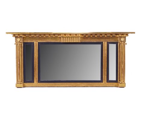 A REGENCY GILT FRAMED TRIPLE PLATE MIRRORWith ball mounted frieze, 130cm wide; 57cm high