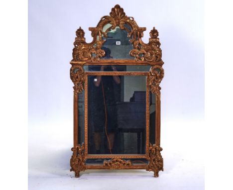 A MODERN GILT FRAMED WALL MIRRORWith arch crest and marginal frame, 71cm wide; 131cm high