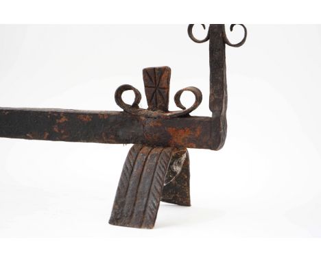 A DOUBLE-ENDED WROUGHT IRON FIRE DOGEach upright terminating in a point and pierced for a ring, fitted with six scroll hooks9