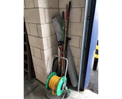 A quantity of garden tools including hose pipe