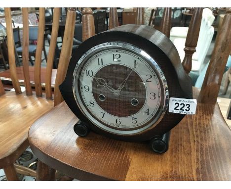 A teak drop shape wooden mantel clock with key and pendulum