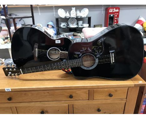 A Hondo X acoustic guitar and a Tanglewood acoustic guitar