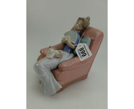 Nao porcelain figure of a woman with fan seated with cat in armchair, height 18cm