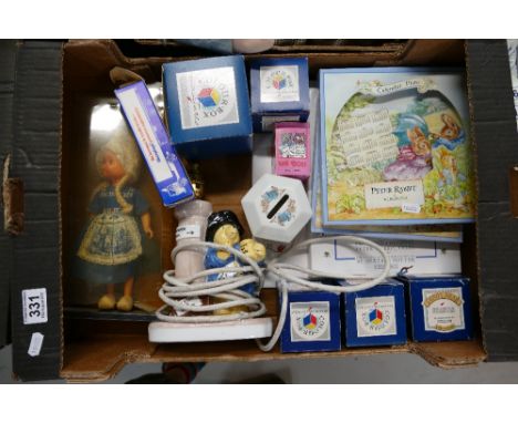 A mixed collection of items to include Wedgwood Peter Rabbit plates, Coalport Paddington Bear table light, Peter Rabbit books