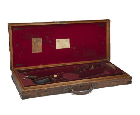 JAMES PURDEY &amp; SONS A BRASS-CORNERED OAK AND LEATHER DOUBLE GUNCASE, fitted for 29 1/2in. barrels, red baize interior (so