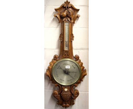 A 19th Century carved oak barometer and thermometer, H. 107cm.