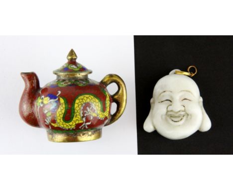 A miniature Chinese cloisonné teapot, H. 5cm, together with a Chinese carved white jade happy Buddha amulet, H. 4cm.