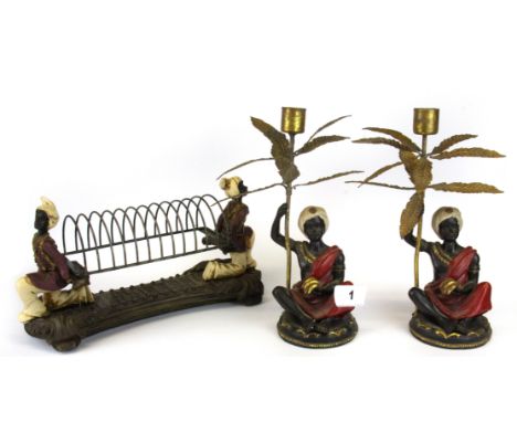 A pair of Blackamoor candlesticks and similar letter rack, Candlestick H. 23cm.