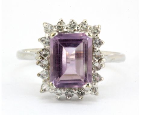 A 9ct white gold emerald cut amethyst and white stone set cluster ring, (N.5).