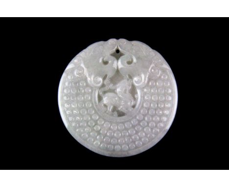 A Chinese carved pale celadon jadeite jade pendant of a coiled dragon with a dragon in the centre, Dia. 5cm.