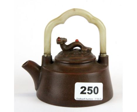 A Chinese Yixing terracotta teapot with white jade handle, H. 11cm.