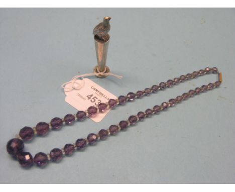 A silver seal, with bird surmount, and an amethyst-coloured bead necklace