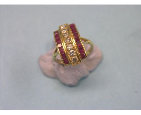 An Art Deco 18ct. gold dress ring, numerous ruby and diamond chips, angular setting, size K