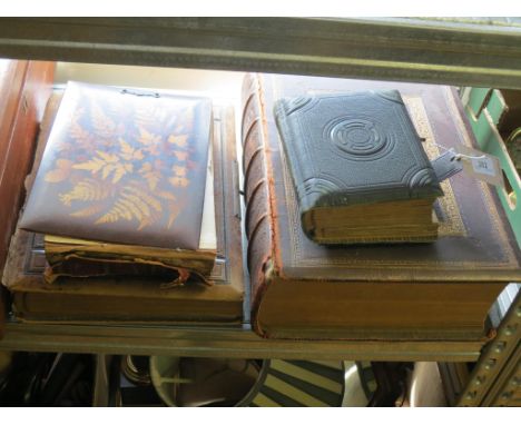 Three Victorian family portrait photograph albums, as viewed also to include a large Victorian family bible 
