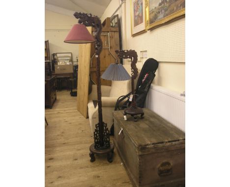 A Chinese hardwood floor-lamp, and related table lamp, each carved with dragon supports