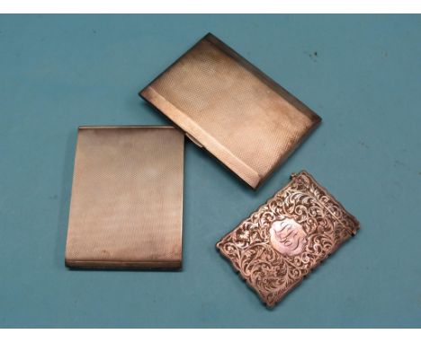 A late Victorian engraved silver card case, Chester 1899, monogrammed, and two engine-turned silver cigarette cases, approx. 