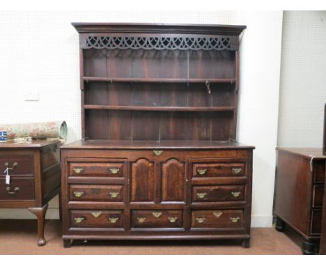 A mid-18th century oak dresser, (modified), twin-shelf plate-rack with broad open-work frieze, lower section with oak cross-b