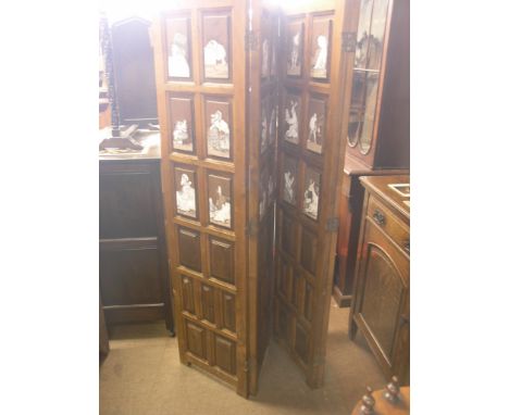 A walnut four-leaf screen, outer leaves each inset with six ceramic tiles, comical scenes, indistinctly signed, 5ft. 7in. hig