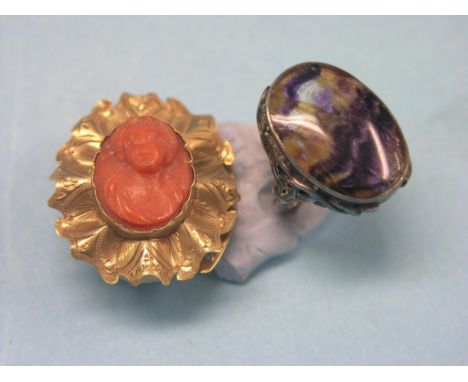 A large silver dress ring, set oval Blue John stone, and a yellow metal and coral brooch, inset carved female portrait bust 