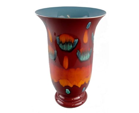 A Poole Pottery vase, in the Delphis range of tapering form with flared rim and stepped pedestal base, painted with stylised 
