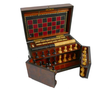 A Victorian walnut games compendium, of oblong form the hinged lid with removable two-sided games board, opening to reveal a 