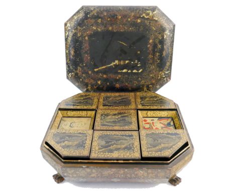 A Chinese lacquered games box, of elongated octagonal form with slightly domed lift-off lid and four paw feet opening to reve