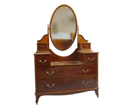 An Edwardian inlaid mahogany triple wardrobe with matching dressing chest, the wardrobe with moulded and inlaid cornice on a 