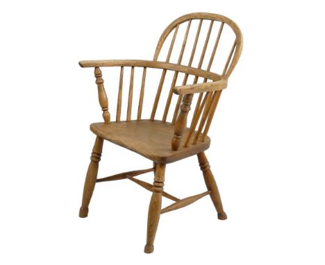 A Victorian oak and elm Windsor chair, with arched low stick back, turned arm supports and legs and H-stretcher