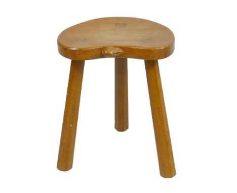 A Peter 'Rabbitman' Heap of Wetwang oak milking stool, with kidney shaped top, three slightly tapering octagonal legs and car