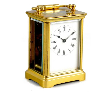 A brass carriage clock, the white enamel dial with Roman numerals, to a plain case, height 11 cm. Sold with a service/overhau