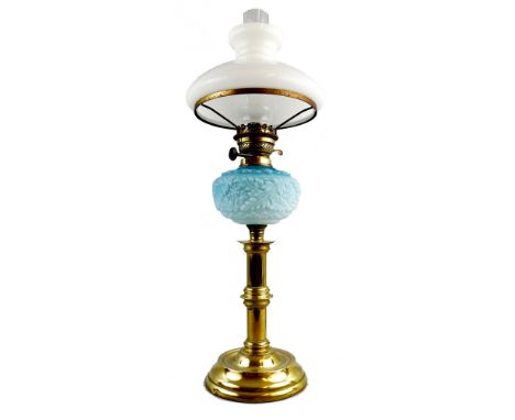 A late Victorian table oil lamp, with brass stepped circular base and knopped column, moulded blue pearline glass reservoir, 