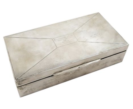 A silver presentation cigarette case, Birmingham 1926, of rectangular form with engine turned decoration, opening to reveal a