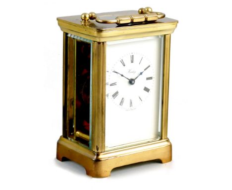 Henley - a brass carriage clock, the white enamel dial with Roman numerals to a plain case, key, height 12 cm.