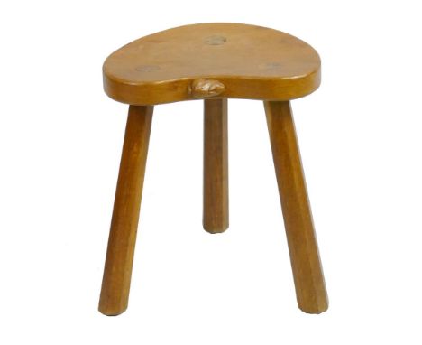 A Peter 'Rabbitman' Heap of Wetwang oak milking stool, with kidney shaped top, three slightly tapering octagonal legs and car