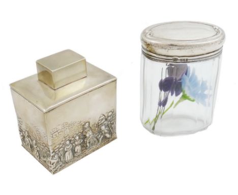 A silver tea caddy, by Nathan & Hayes, Chester 1912, of rectangular form with a pull off cover, embossed and chased with a pa